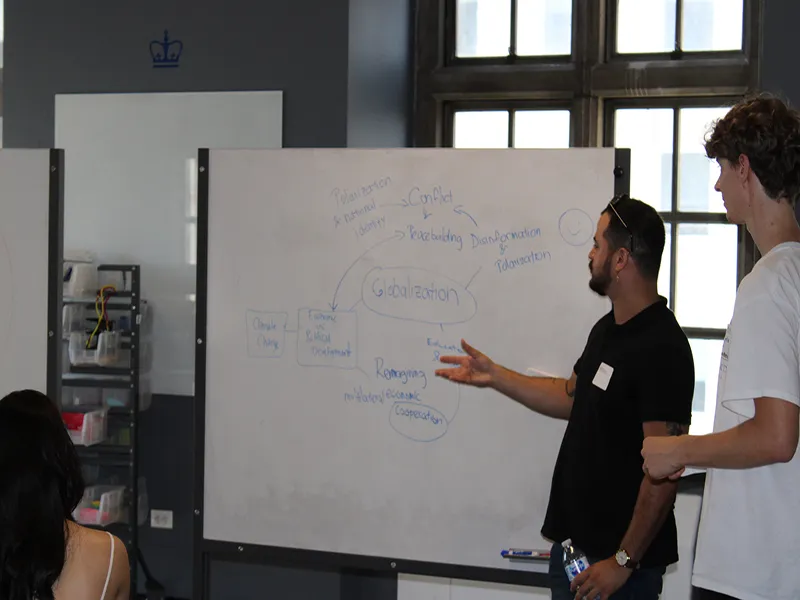Two students present at whiteboard 