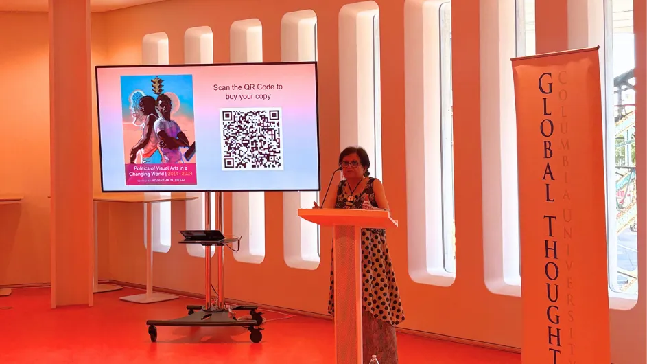 Vishakha speaking at the podium